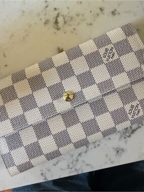 Louis Vuitton Sarah wallet is crafted from signature Damier Azur canvas
